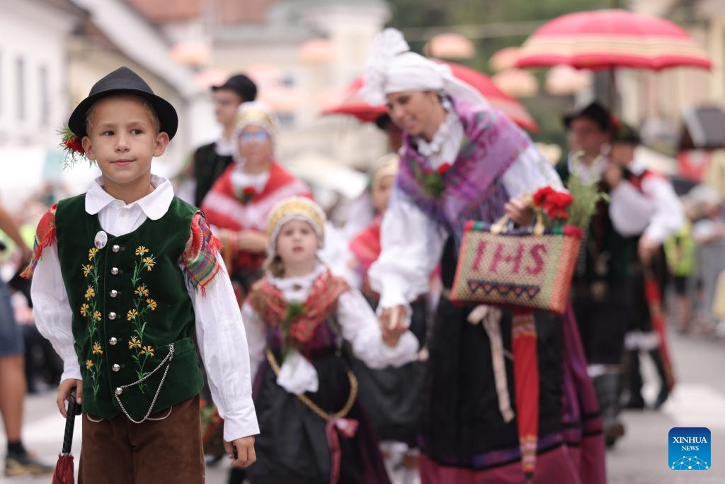 A boy wearing Slovenian traditional costume participates in the parade of the 51st National Costumes and Clothing Heritage Day in Kamnik, Slovenia, Sept. 8, 2024. The 51st National Costumes and Clothing Heritage Day ended Sunday in Kamnik with a traditional parade, during which about 2,000 participants dressed in national costumes walking through the center of Kamnik. (Photo: Xinhua)