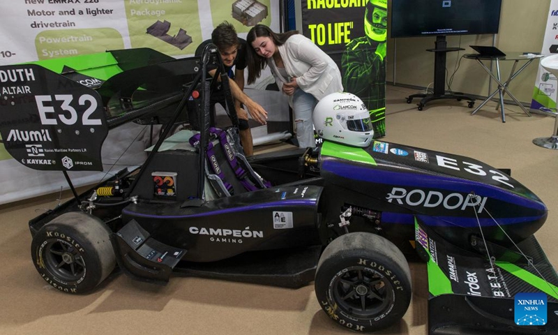 A woman watches a mini race car at the 88th Thessaloniki International Fair, in Thessaloniki, Greece, on Sep. 8, 2024. The 88th Thessaloniki International Fair, the largest annual trade fair in Greece, is held here from Sept. 7 to 15. (Photo: Xinhua)