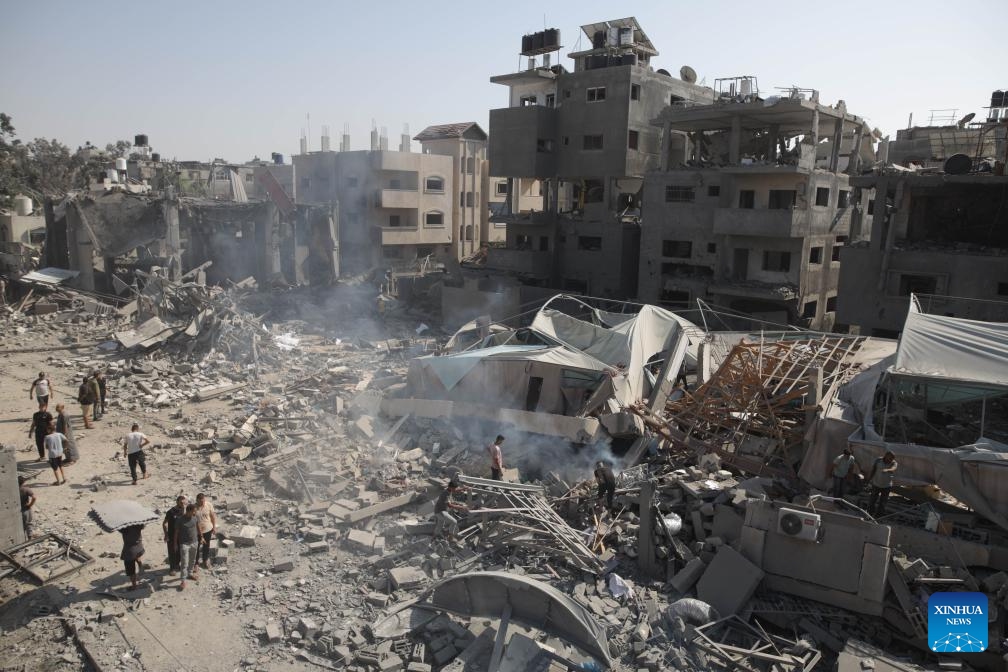 People are seen near destroyed buildings in the Al-Bureij refugee camp, central Gaza Strip, on Sept. 10, 2024. Palestinian security and medical sources on Tuesday reported that Israeli warplanes had targeted the al-Farouk Mosque and the youth club in the Al-Bureij refugee camp. Medical sources told Xinhua that the airstrike killed one person and injured 10 others, who were taken to the hospital with varying degrees of injuries. (Photo: Xinhua)