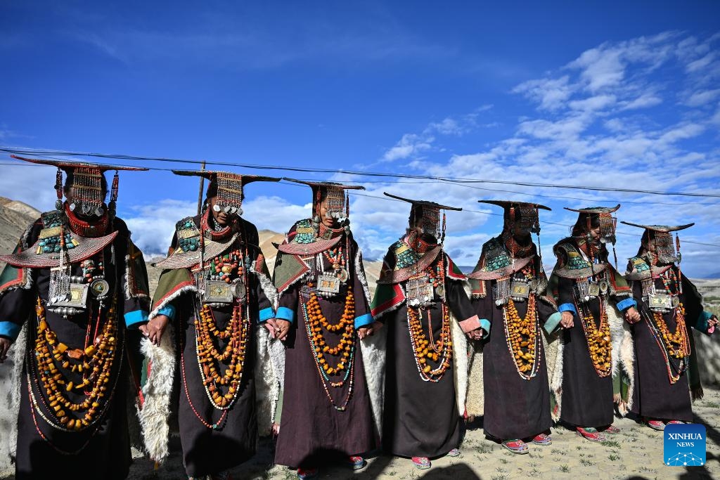 Villagers dressed in folk costume dance in Kejia Village of Pulan County, southwest China's Xizang Autonomous Region, Sept. 9, 2024. Originating in Pulan County, Pulan folk costume has been a traditional garment worn at celebrations for over a millennium. Weighing more than 20 kilograms, a piece of this unique costume is usually decorated with rare metals and jewels, like gold, silver, beeswax, coral and turquoise. (Photo: Xinhua)