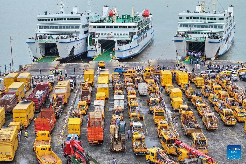 A drone photo taken on Sept. 7, 2024 shows emergency power repair personnel and vehicles waiting to board ships heading to Hainan at a port in Xuwen County, south China's Guangdong Province. Super Typhoon Yagi, the strongest autumn typhoon to land in China since 1949, hit Hainan on Friday and caused power outages in many areas. (Photo: Xinhua)