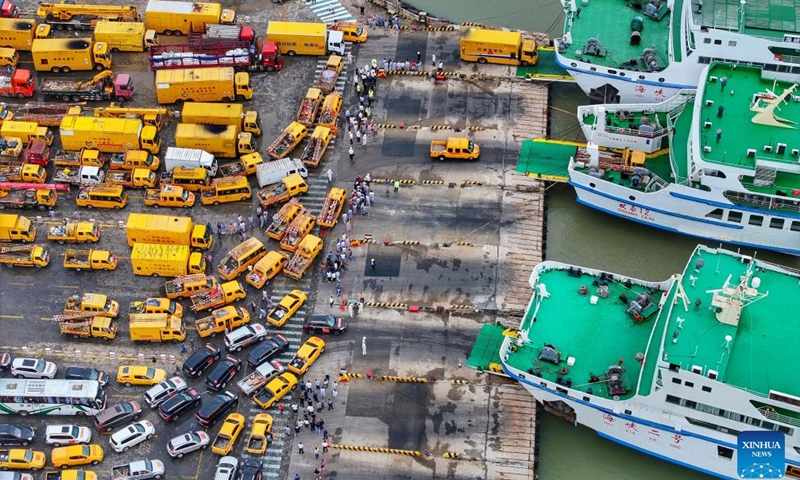 An aerial drone photo taken on Sept. 7, 2024 shows emergency power repair personnel and vehicles waiting to board ships heading to Hainan at a port in Xuwen County, south China's Guangdong Province. Super Typhoon Yagi, the strongest autumn typhoon to land in China since 1949, hit Hainan on Friday and caused power outages in many areas. (Photo: Xinhua)