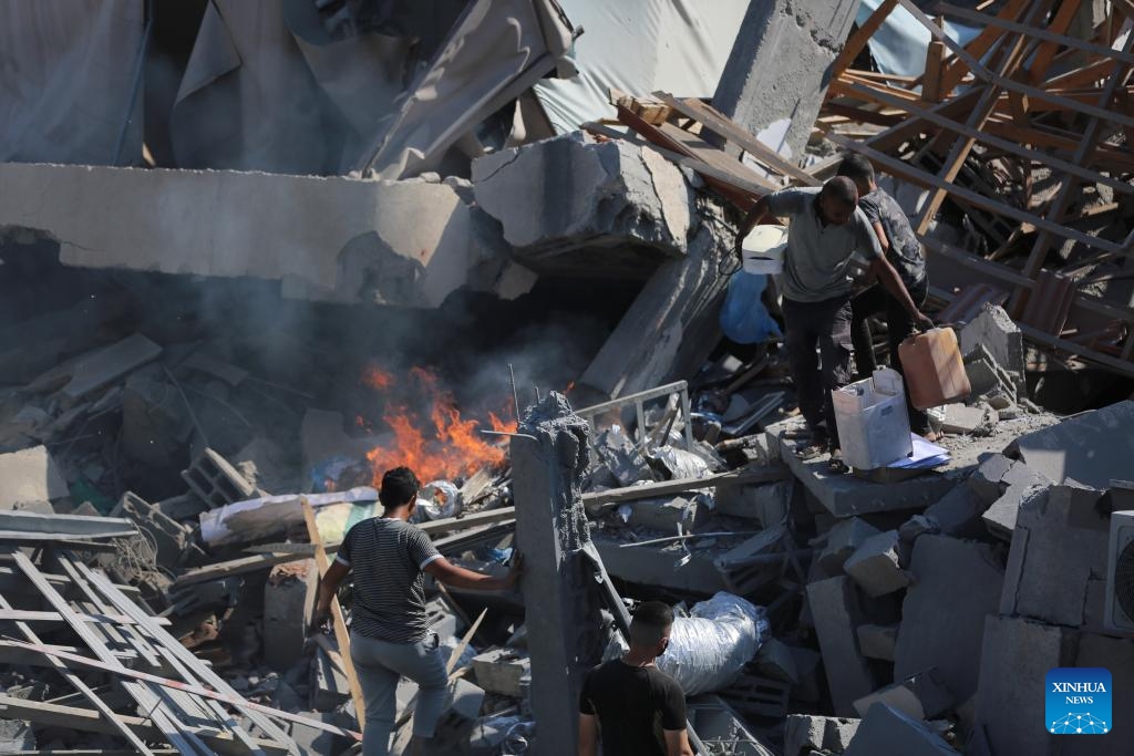 People are seen among the rubble of a destroyed building in the Al-Bureij refugee camp, central Gaza Strip, on Sept. 10, 2024. Palestinian security and medical sources on Tuesday reported that Israeli warplanes had targeted the al-Farouk Mosque and the youth club in the Al-Bureij refugee camp. Medical sources told Xinhua that the airstrike killed one person and injured 10 others, who were taken to the hospital with varying degrees of injuries. (Photo: Xinhua)