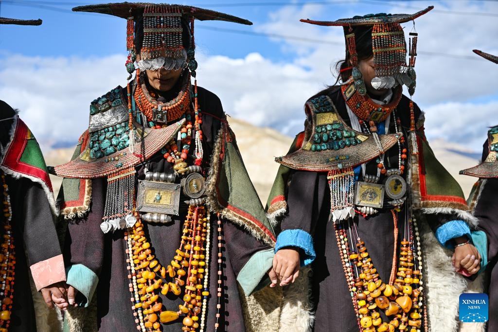 Villagers dressed in folk costume dance in Kejia Village of Pulan County, southwest China's Xizang Autonomous Region, Sept. 9, 2024. Originating in Pulan County, Pulan folk costume has been a traditional garment worn at celebrations for over a millennium. Weighing more than 20 kilograms, a piece of this unique costume is usually decorated with rare metals and jewels, like gold, silver, beeswax, coral and turquoise. (Photo: Xinhua)