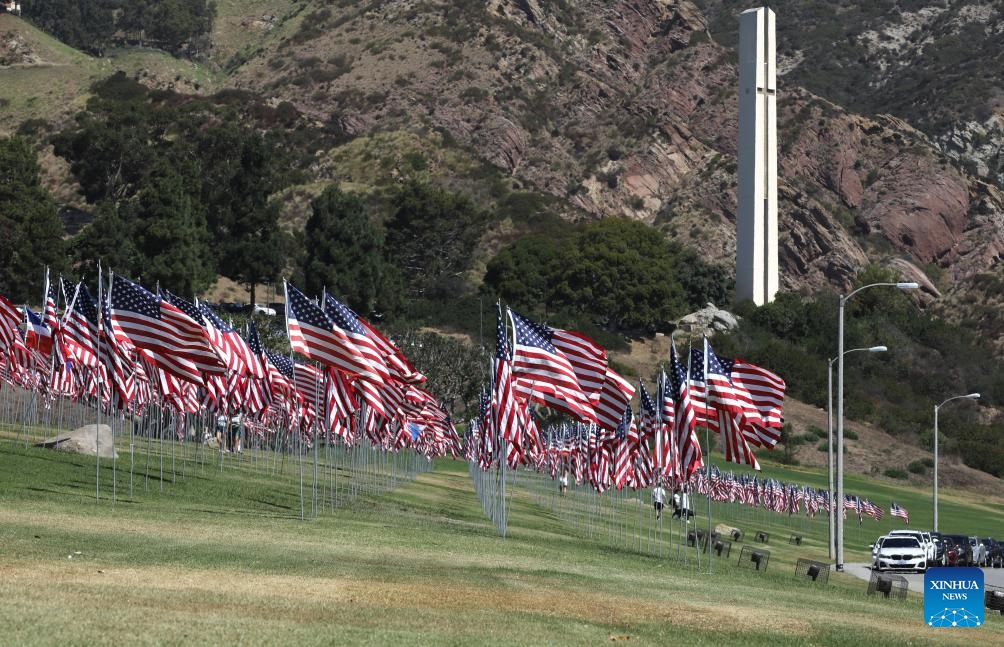 People walk among the Waves of Flags at Pepperdine University in Malibu, California, the United States, on Sept. 10, 2024. Each September, the university stages the Waves of Flags display to honor the victims of the 9/11 attacks. (Photo: Xinhua)