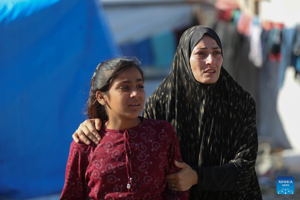 People gather near a UN-run school sheltering displaced people after it was attacked by the Israeli army in the al-Nuseirat refugee camp, central Gaza Strip, on Sept. 11, 2024. At least 14 Palestinians were killed and 10 others wounded in an Israeli airstrike on a UN-run school sheltering displaced people in the central Gaza Strip, according to Palestinian sources on Wednesday. (Photo: Xinhua)