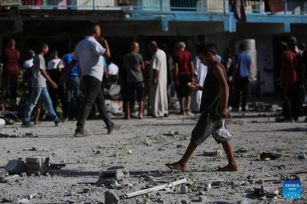 People gather at a UN-run school sheltering displaced people after it was attacked by the Israeli army in the al-Nuseirat refugee camp, central Gaza Strip, on Sept. 11, 2024. At least 14 Palestinians were killed and 10 others wounded in an Israeli airstrike on a UN-run school sheltering displaced people in the central Gaza Strip, according to Palestinian sources on Wednesday. (Photo: Xinhua)