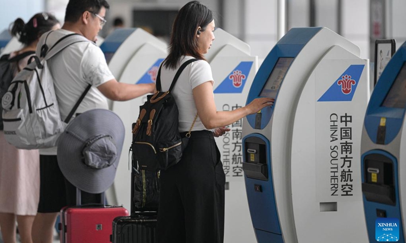 Passengers check in at Haikou Meilan International Airport in Haikou, south China's Hainan Province, Sept. 11, 2024. Hainan has witnessed its production gradually resumed after Super Typhoon Yagi, the 11th typhoon of the year, made landfall in Hainan on Friday and brought damage across the island. (Photo: Xinhua)