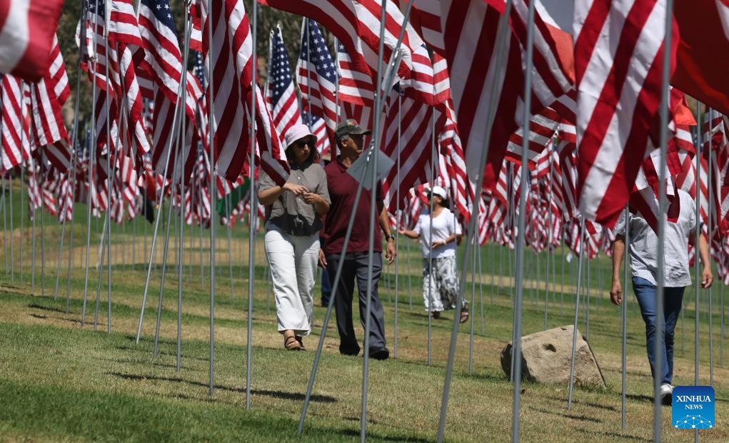 People walk among the Waves of Flags at Pepperdine University in Malibu, California, the United States, on Sept. 10, 2024. Each September, the university stages the Waves of Flags display to honor the victims of the 9/11 attacks. (Photo: Xinhua)