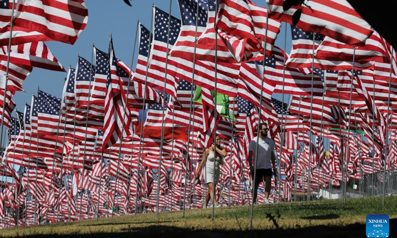 People walk among the Waves of Flags at Pepperdine University in Malibu, California, the United States, on Sept. 10, 2024. Each September, the university stages the Waves of Flags display to honor the victims of the 9/11 attacks. (Photo: Xinhua)