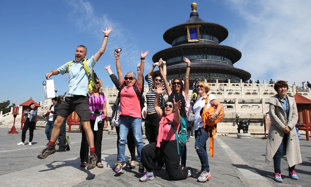 Foreign tourists enjoy themselves at Tiantan,<strong></strong> a UNESCO World Heritage Site built in 1420, in Beijing. China's tourism industry is booming and the nation has become the largest source of international tourists. More than 14 million foreign nationals entered China in the first half of 2024, according to the National Immigration Administration. Photo: VCG