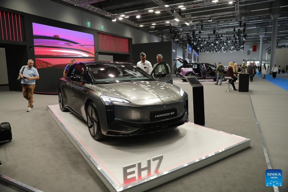 People visit the booth of Hongqi at the Automechanika in Frankfurt, Germany, Sept. 11, 2024. A leading trade fair for the aftermarket sector of the auto industry, Automechanika, kicked off on Tuesday, highlighting electrification and sustainability.(Photo: Xinhua)