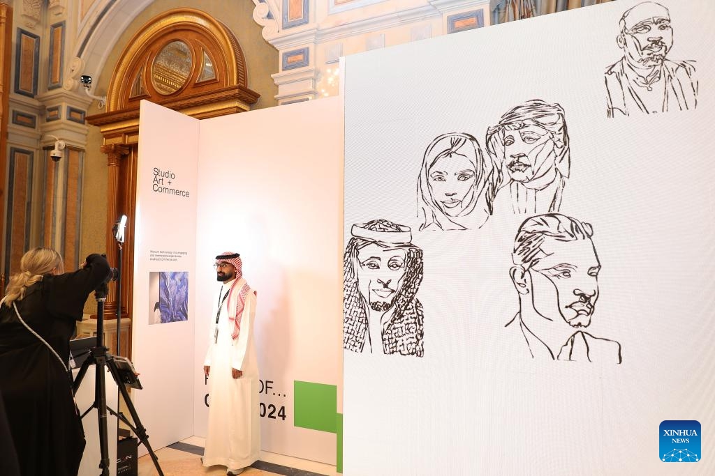 Visitors experience documenting faces of people with AI during the third edition of the Global AI Summit (GAIN) in Riyadh, Saudi Arabia, Sept. 10, 2024. (Photo: Xinhua)