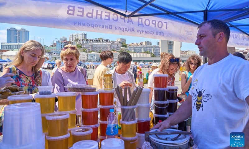 A beekeeper displays a wide variety of honey products during the Honey Day held in Vladivostok, Russia, Sept. 12, 2024. (Photo: Xinhua)