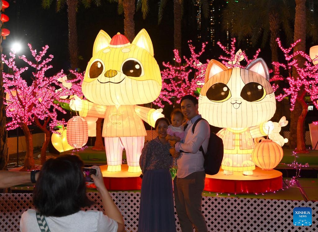 A woman poses for photos at a lantern fair marking the upcoming Mid-Autumn Festival and National Day at Victoria Park in Hong Kong, south China, Sept. 12, 2024. (Photo: Xinhua)