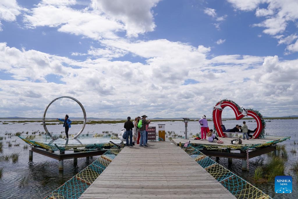 Tourists visit the Huahu Lake scenic spot in Ruoergai Wetland National Nature Reserve, in Ruoergai County of Aba Tibetan-Qiang Autonomous Prefecture, southwest China's Sichuan Province, Sept. 5, 2024. The Ruoergai Wetland National Nature Reserve is established to protect local peat swamp ecosystem and rare species such as the black-necked crane. The ecological environment of protected areas has witnessed a continuous improvement in recent years as the local government implemented substantial measures in ecological restoration and management. (Photo: Xinhua)