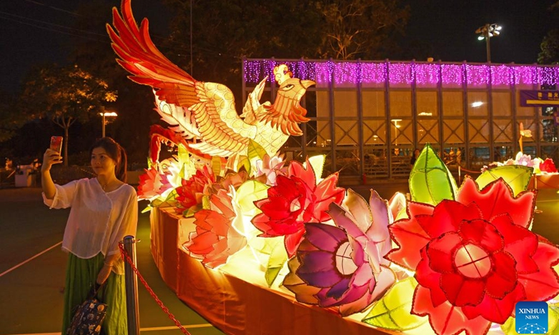 A woman takes selfies at a lantern fair marking the upcoming Mid-Autumn Festival and National Day at Victoria Park in Hong Kong, south China, Sept. 12, 2024. (Photo: Xinhua)