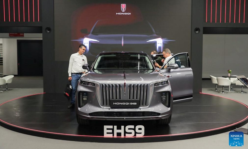 People visit the booth of Hongqi at the Automechanika in Frankfurt, Germany, Sept. 11, 2024. A leading trade fair for the aftermarket sector of the auto industry, Automechanika, kicked off on Tuesday, highlighting electrification and sustainability.(Photo: Xinhua)