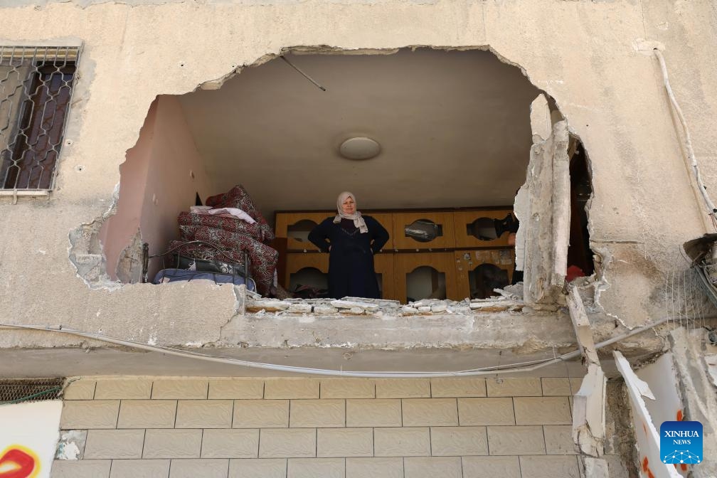 A Palestinian woman inspects the damage of a building that was attacked by Israeli army in the refugee camp of Tulkarm in the north of the West Bank, Sept. 12, 2024. (Photo: Xinhua)