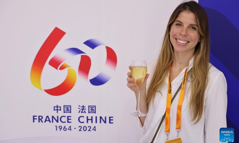 A staff member shows a glass of champagne at the national pavilion of France at the China National Convention Center during the 2024 China International Fair for Trade in Services (CIFTIS) in Beijing, capital of China, Sept. 12, 2024.