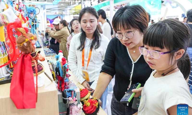 Visitors view cultural creative products at the exhibition stand of Tongzhou District of Beijing during the 2024 China International Fair for Trade in Services (CIFTIS) at the Shougang Park in Beijing, capital of China, Sept. 15, 2024.