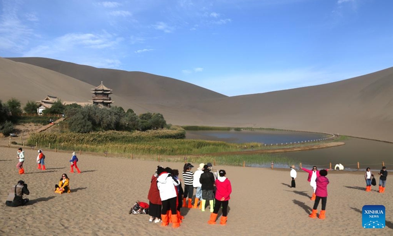 People visit the Mingsha Mountain and Crescent Spring scenic spot in the city of Dunhuang, northwest China's Gansu Province, Sept. 15, 2024. The Mid-Autumn Festival is one of China's most important traditional holidays. Taking place annually on the 15th day of the eighth month in the Chinese lunar calendar, it will be observed on Sept. 17 this year. (Photo: Xinhua)