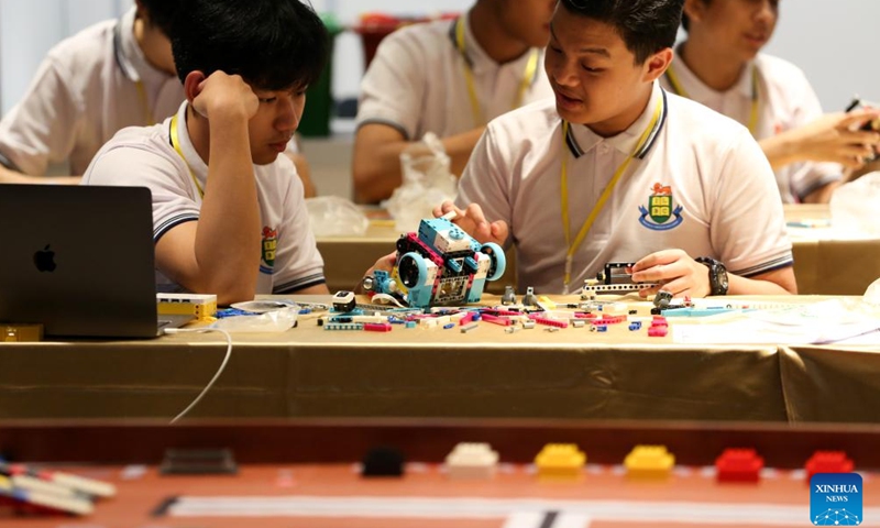 Students work on their robot during a contest of World Robot Olympiad 2024 in Yangon, Myanmar, Sept. 15, 2024.