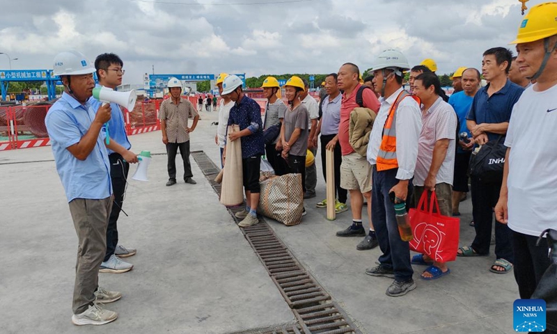 Workers prepare to evacuate to a temporary relocation site at Lingang campus project of Shanghai Pudong Hospital in east China's Shanghai, Sept. 15, 2024. (Xinhua/Fang Zhe)