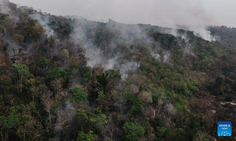 A drone photo taken on Sept. 13, 2024 shows smoke rises in Amazon rainforest in Sao Lourenco in the state of Rondonia, Brazil. Data recently released by Brazil's National Center for Monitoring and Early Warning of Natural Disasters shows that this year, drought has affected approximately 5 million square kilometers, impacting about 59 percent of the country's territory. (Xinhua/Wang Tiancong)