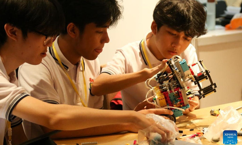 Students work on their robot during a contest of World Robot Olympiad 2024 in Yangon, Myanmar, Sept. 15, 2024.