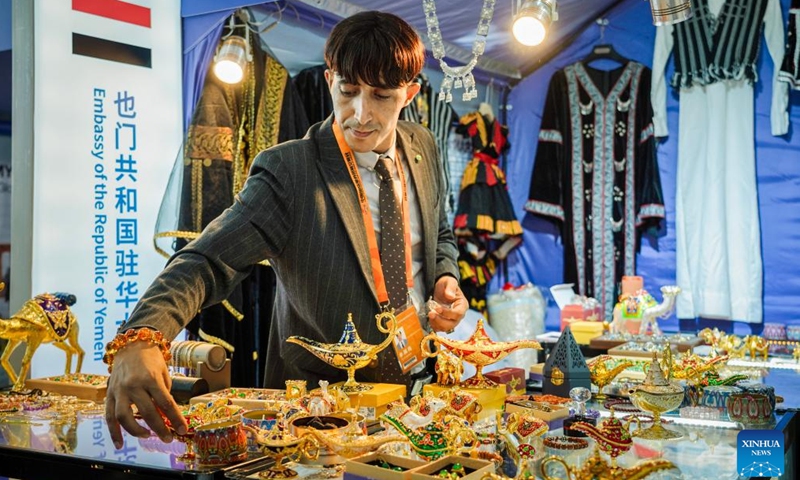 A staff member arranges exhibits at the booth of Embassy of the Republic of Yemen during the 2024 China International Fair for Trade in Services (CIFTIS) at the Shougang Park in Beijing, capital of China, Sept. 14, 2024. 