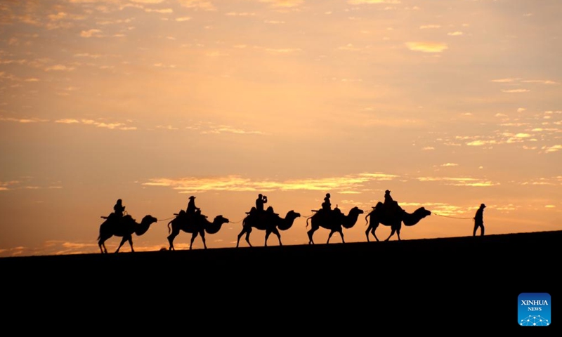 People visit the Mingsha Mountain and Crescent Spring scenic spot in the city of Dunhuang, northwest China's Gansu Province, Sept. 15, 2024. The Mid-Autumn Festival is one of China's most important traditional holidays. Taking place annually on the 15th day of the eighth month in the Chinese lunar calendar, it will be observed on Sept. 17 this year. (Photo: Xinhua)