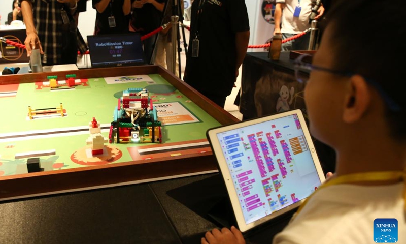 A student participates in a contest of World Robot Olympiad 2024 in Yangon, Myanmar, Sept. 15, 2024. Myanmar organized a robot competition in Yangon on Sunday, attracting over 50 participants from 15 teams across the country. The event, featuring two main categories: Robo Mission and Future Innovators, aimed to provide Myanmar's students with a platform to showcase their robotics skills and compete internationally, Eddi, organizer of the event told Xinhua on Sunday. (Xinhua/Myo Kyaw Soe)