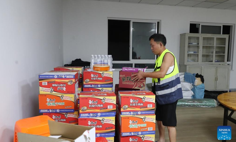 A staff member arranges emergency foods at a temporary relocation site ahead of the landfall of Typhoon Bebinca in Pudong, east China's Shanghai, Sept. 15, 2024. (Xinhua/Fang Zhe)