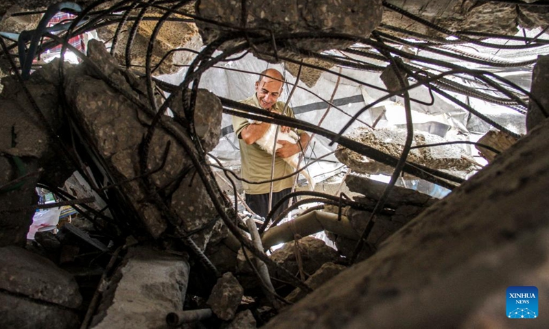 A Palestinian man is seen living in a tent set on the rubble of his destructed house in the refugee camp of Jabalia, northern Gaza Strip, on Sept. 16, 2024. (Photo: Xinhua)