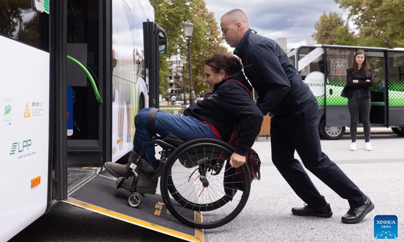 People demonstrate entering a city bus with a wheelchair during the European Mobility Week in Ljubljana, Slovenia, on Sept. 16, 2024. Many Slovenian cities and towns hosted events promoting sustainable transport options to mark the European Mobility Week on Monday. (Photo: Xinhua)