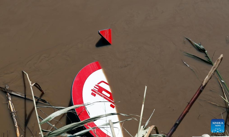 A traffic sign is seen in the muddy water of Suhurlui river in Galati County, Romania, Sept. 16, 2024. Galati County, Romania, is struggling to recover from the severe floods brought by Cyclone Boris on Saturday, which has claimed five lives and displaced over 250 residents.  (Photo: Xinhua)