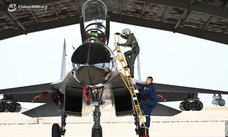 A pilot assigned to an aviation regiment under the Chinese PLA Air Force climbs into the cockpit to get ready for an air battle training exercise in early July, 2024. (Photo:China Military Online)