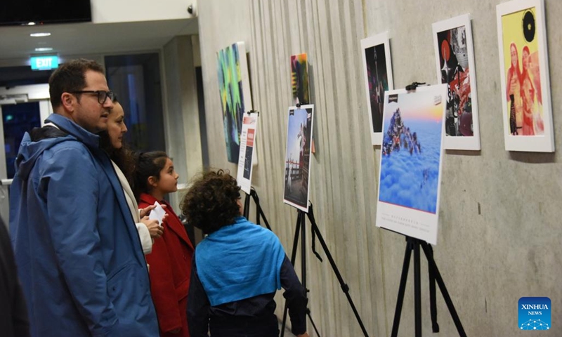 Visitors watch a Hubei's travel route exhibition before the celebration, dubbed Ode to the Moon, in the city of Christchurch, New Zealand South Island, Sept. 15, 2024. This event aims to celebrate the Mid-Autumn Festival and sister-city ties between Hubei's capital Wuhan and Christchurch. Featuring dance, songs, instrumental ensemble, as well as acrobatics, magic show and tai-chi demonstrations, the performances attracted more than 700 people.(Photo: Xinhua)