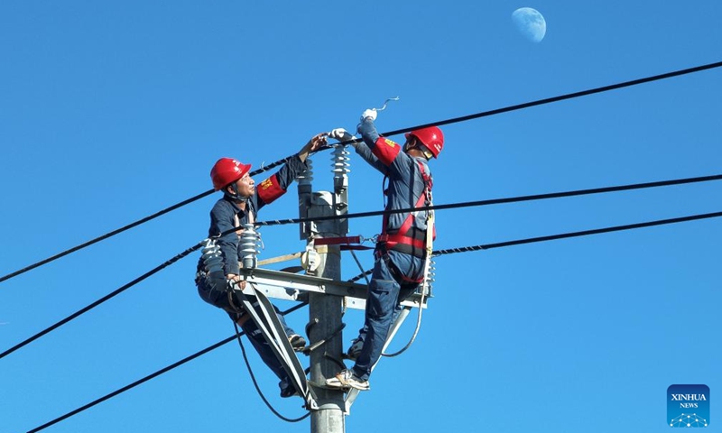 A drone photo taken on Sept. 13, 2024 shows maintenance workers Chen Hongfei (L) and Yao Jianglian repairing power facilities in Longlou Township of Wenchang City, south China's Hainan Province. Due to the impact of Super Typhoon Yagi, power facilities were damaged in different places in Hainan in the past few days.

China Southern Power Grid has organized personnel and made efforts in power repair works to make the province to fully restore power supply as soon as possible. (Photo: Xinhua)