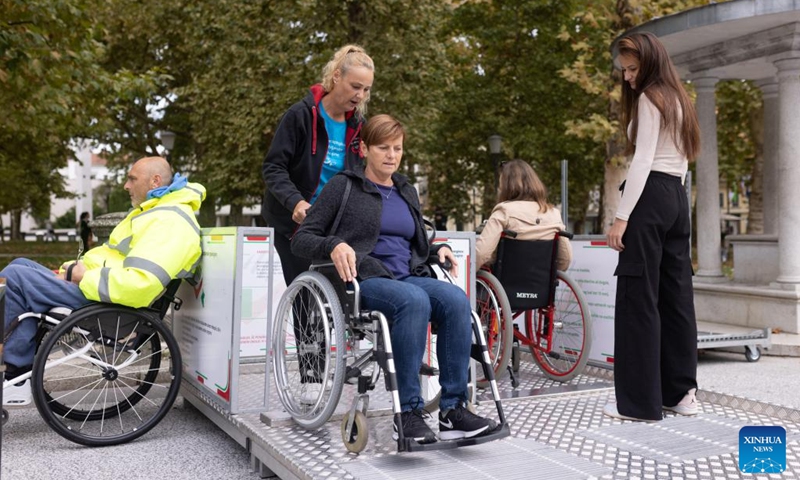 People experience wheelchairs during the European Mobility Week in Ljubljana, Slovenia, on Sept. 16, 2024. Many Slovenian cities and towns hosted events promoting sustainable transport options to mark the European Mobility Week on Monday. (Photo: Xinhua)