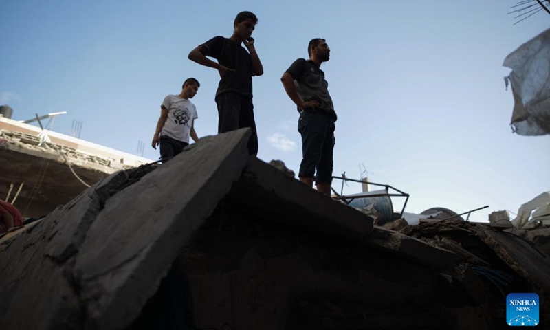 People inspect a destroyed building in the Nuseirat refugee camp, central Gaza Strip, on Sept. 16, 2024. Palestinian security sources told Xinhua on Monday that Israeli aircraft targeted a house in the Nuseirat refugee camp in the central Gaza Strip, killing at least 10.  (Photo: Xinhua)