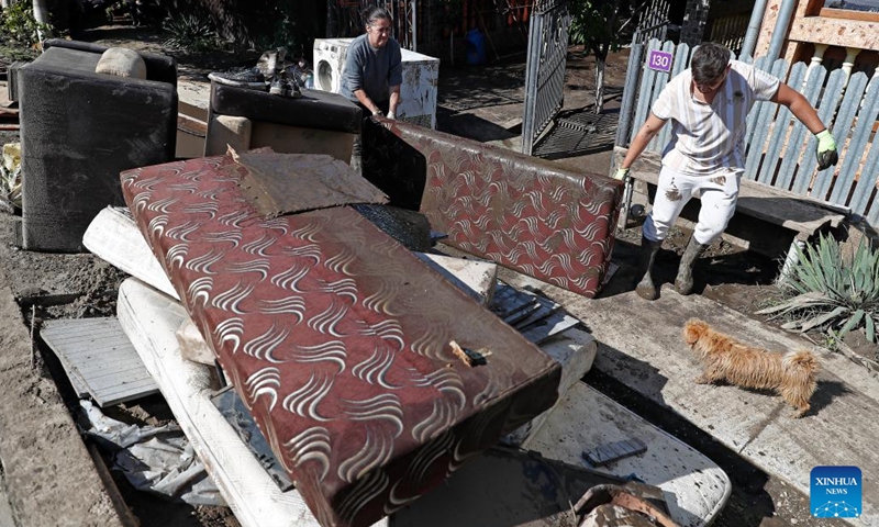 People carry their destroyed belongings after floods in Galati County, Romania, Sept. 16, 2024. Galati County, Romania, is struggling to recover from the severe floods brought by Cyclone Boris on Saturday, which has claimed five lives and displaced over 250 residents.  (Photo: Xinhua)