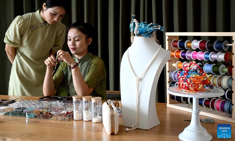 Chu Mengdan (R) teaches her apprentice bead weaving skills at an intangible cultural heritage experience hall in Luoyang City, central China's Henan Province, Sept. 12, 2024.  (Photo: Xinhua)