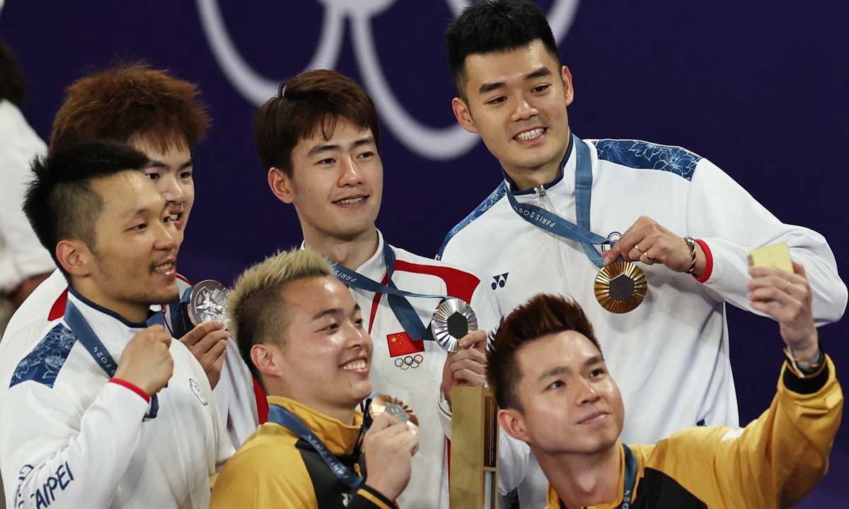 Medal winners take a group photo after the badminton men's doubles at the Paris Olympics on August 4, 2024. Lee Yang and Wang Chi-lin of Chinese Taipei won over Chinese duo Liang Weikeng and Wang Chang to take the badminton men's doubles title. Photo: IC