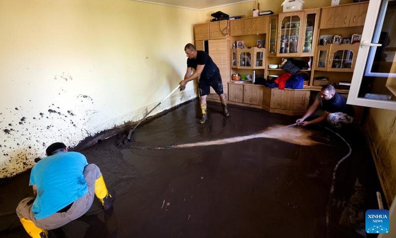 People clean their flood-hit house in Galati County, Romania, Sept. 16, 2024. Galati County, Romania, is struggling to recover from the severe floods brought by Cyclone Boris on Saturday, which has claimed five lives and displaced over 250 residents.  (Photo: Xinhua)