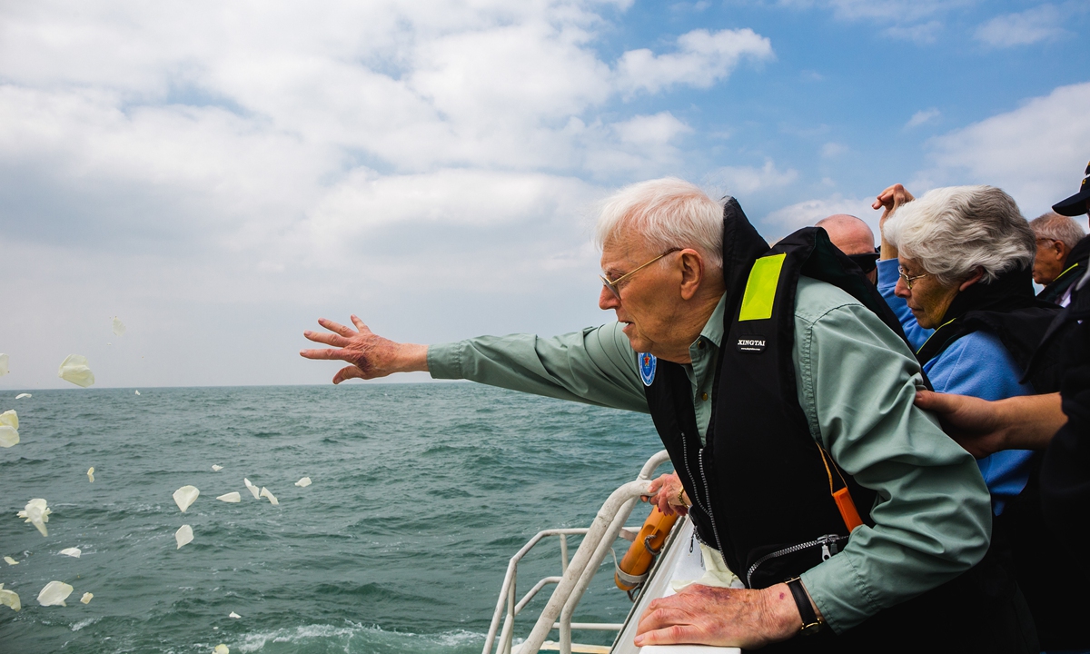 A relative of British POWs pays tribute at the site where the Lisbon Maru sank in 1942, in October 2019. Photo: Courtesy of the production team