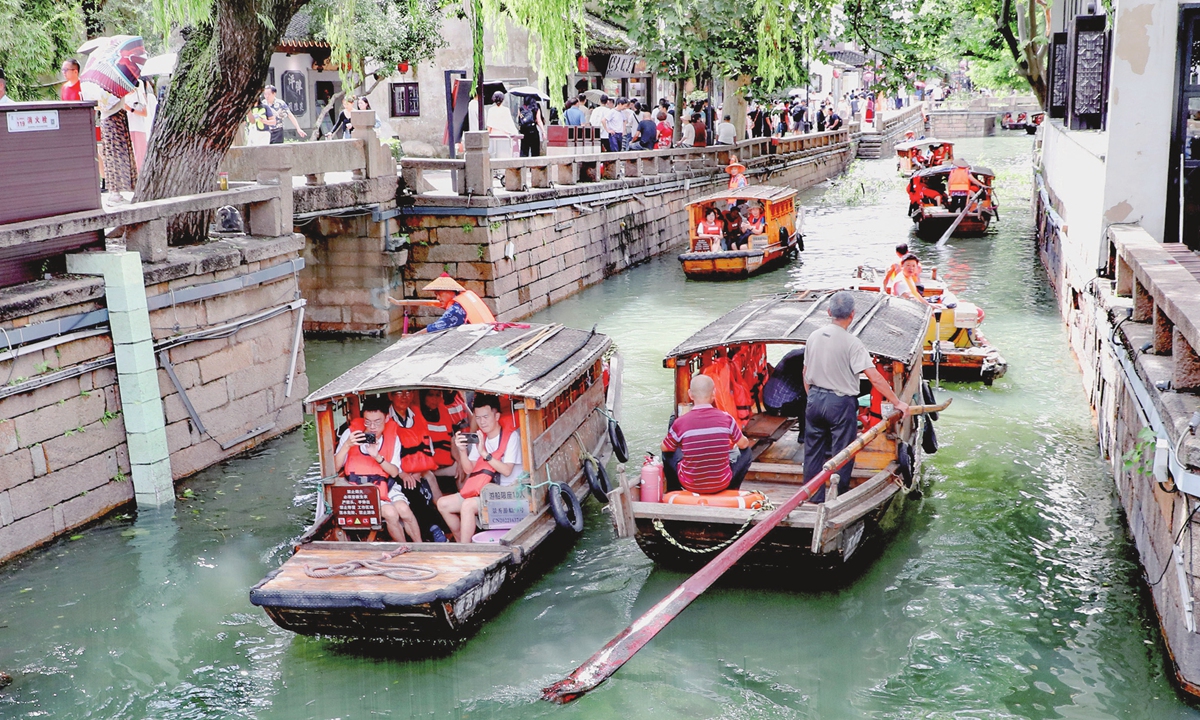 Paddleboats travel back and forth on the Pingjiang River in Suzhou, East China's Jiangsu Province on September 17, 2024. With Bebinca, the 13th typhoon of this year, moving away from Suzhou, the city's scenic spots and ancient streets have been reopened, attracting many residents and tourists to enjoy the Mid-Autumn Festival holidays that ended on September 17. Photo: VCG