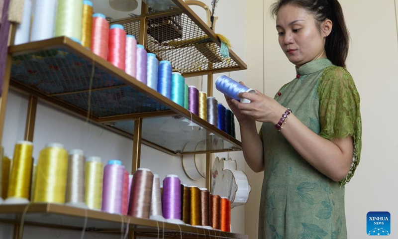 Chu Mengdan selects threads for color matching at an intangible cultural heritage experience hall in Luoyang City, central China's Henan Province, Sept. 12, 2024. (Photo: Xinhua)