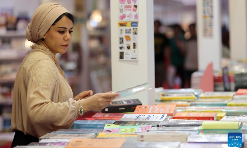 A woman selects a book at the 25th Baghdad International Book Fair in Baghdad, Iraq, on Sept. 17, 2024. (Photo: Xinhua)